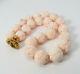 18k Gold, Diamond, Carved Angel Skin Coral Bead Necklace